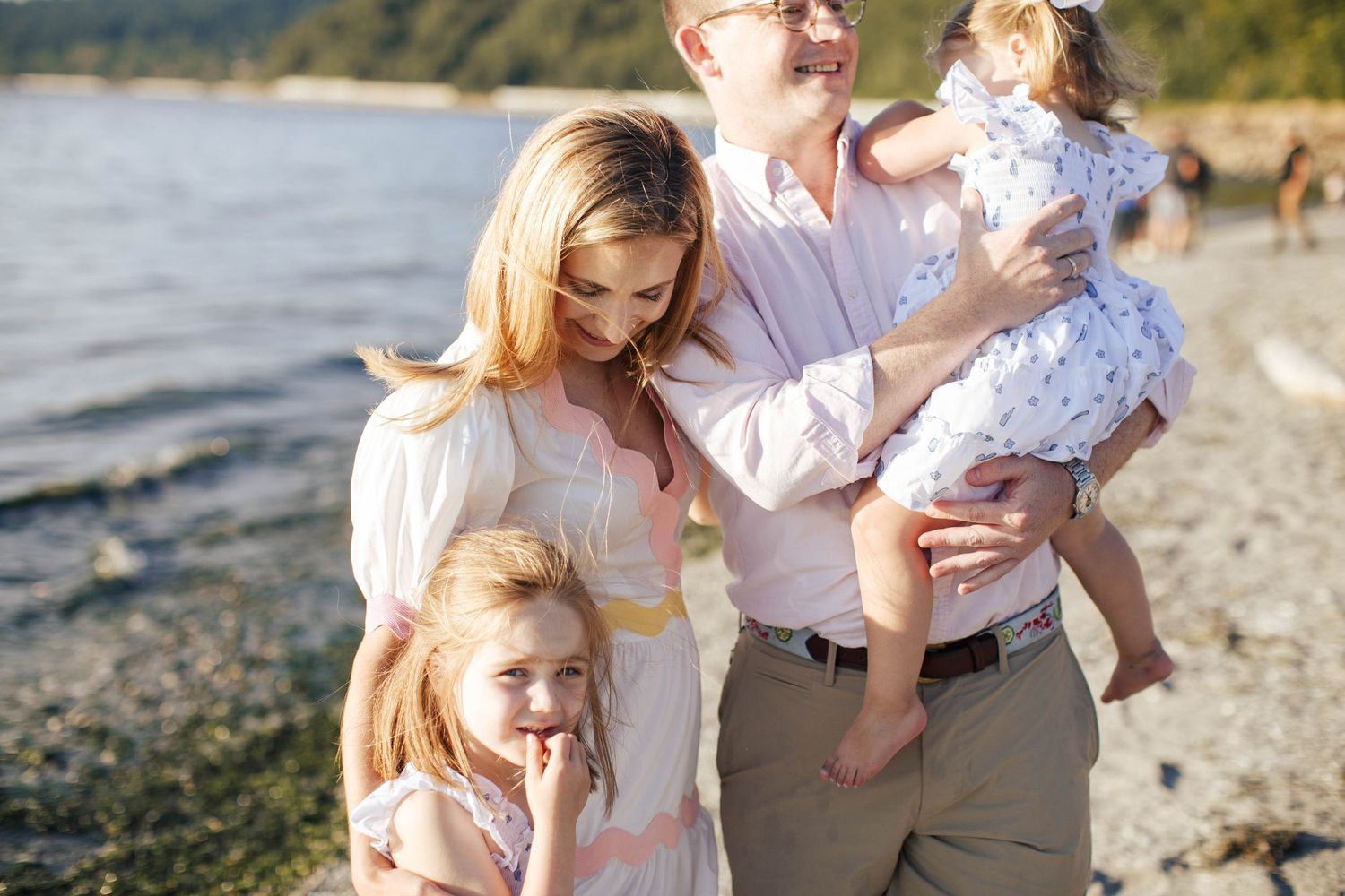 Seattle family photographer: A mother, father and their two daughters at  Carkeek Park Beach in Seattle