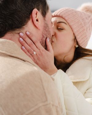 An intimate moment captured between a couple during their winter engagement photoshoot.