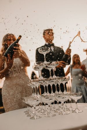 A stop motion sequence showing champagne glasses being filled and stacked into a tower formation during a celebration.