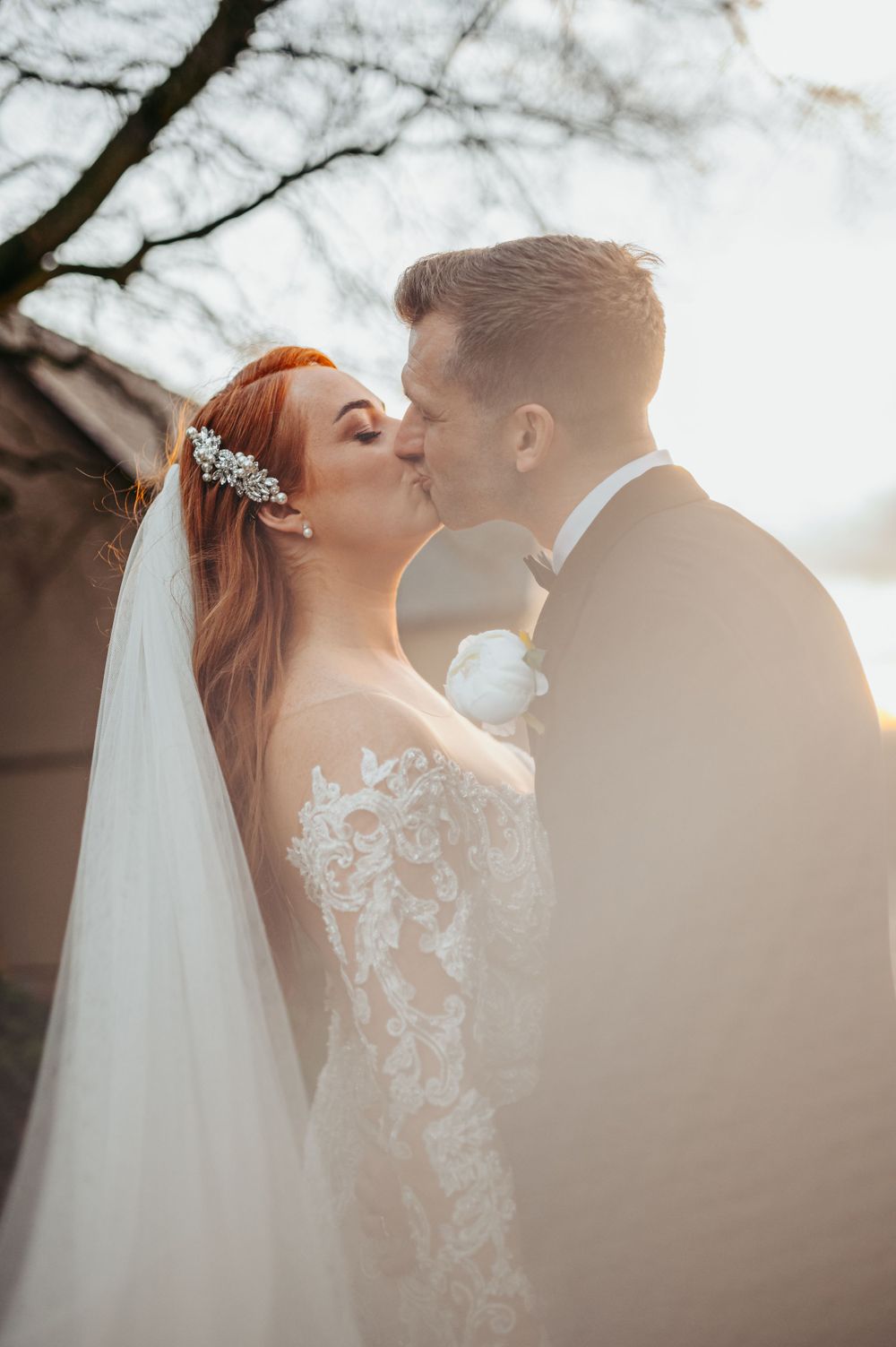 Intimate wedding portrait showing tender moment between newlyweds outdoors.