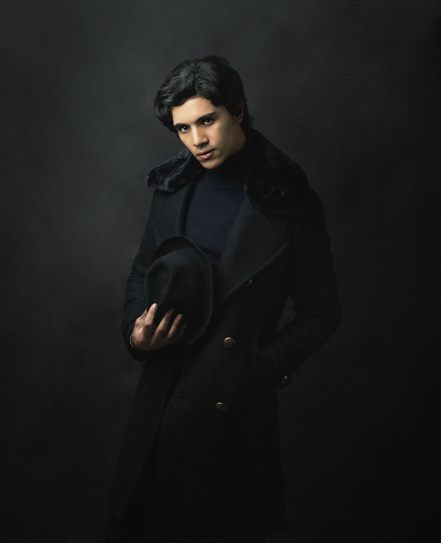 Portrait of a man with a hat and coat, Studio photography. Fashion photography