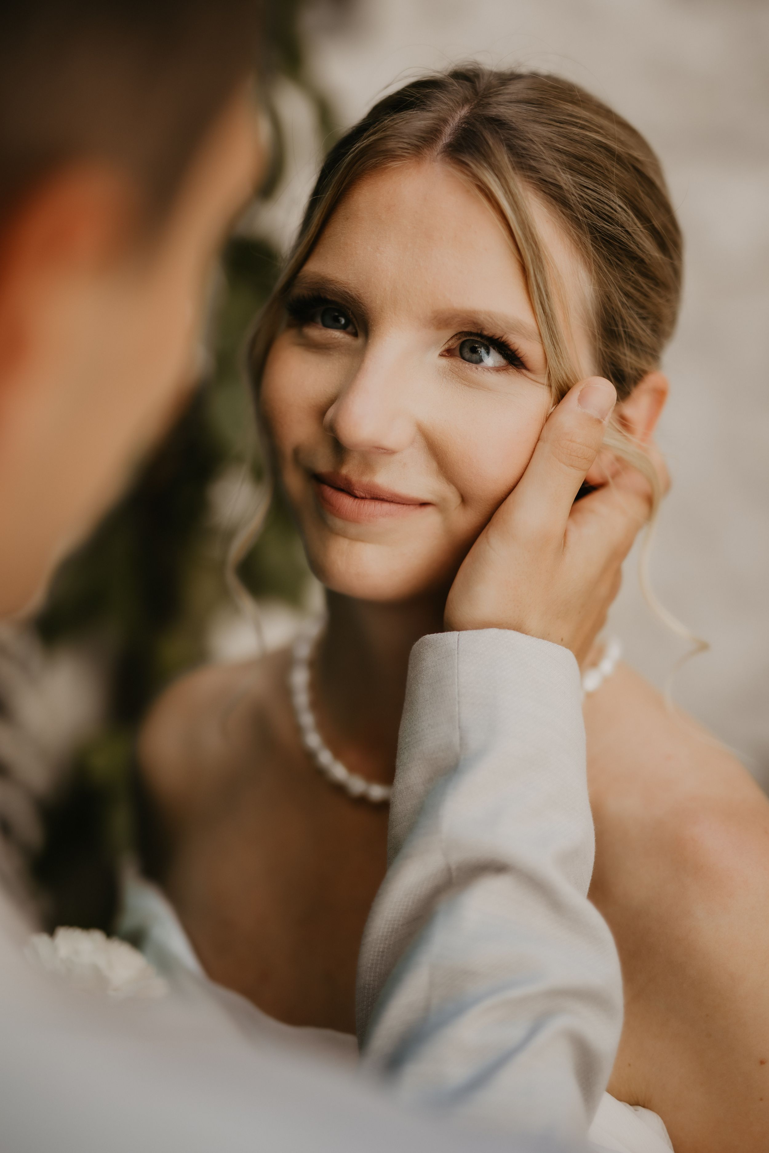 A tender close-up moment between newlyweds during their wedding photoshoot.