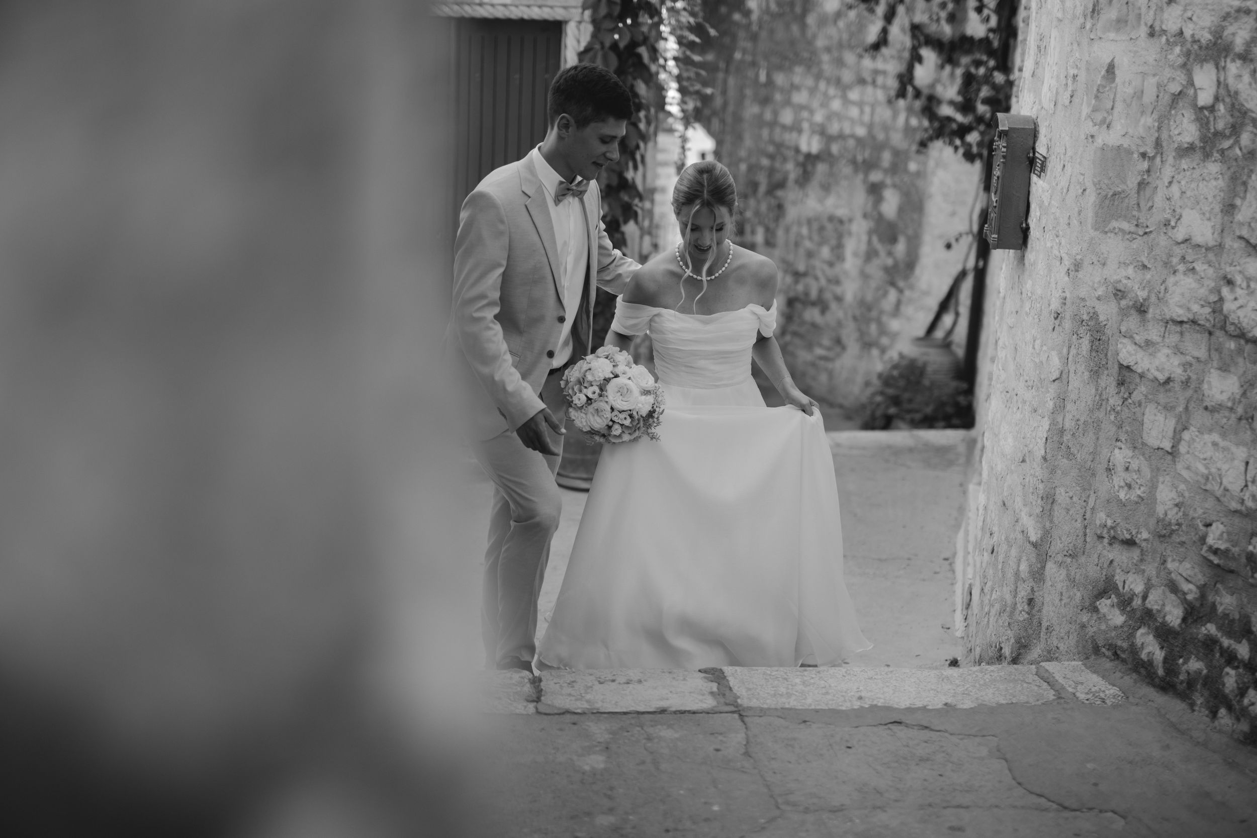 A black and white wedding photo showing a couple sharing a quiet moment together.