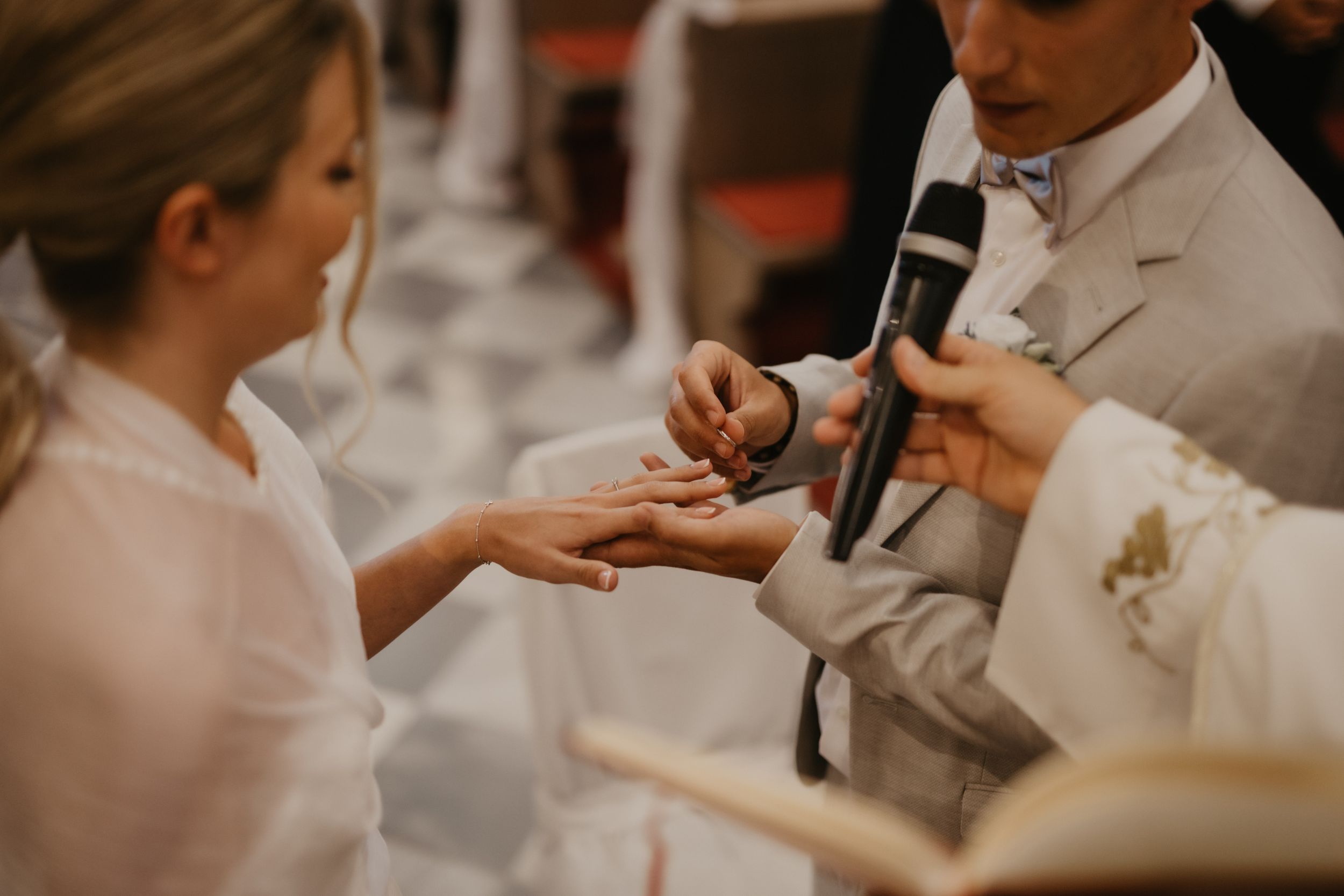 Wedding ring exchange during traditional church ceremony.