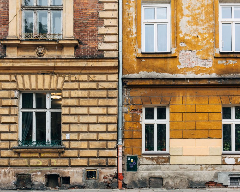 Contrasting yellow and beige building facades with traditional European architectural details.