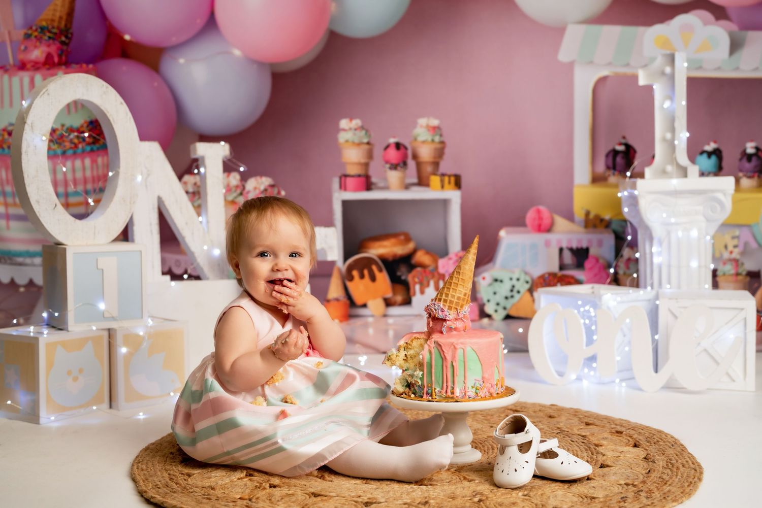 1 year old enjoying a 1st birthday cake smash session in a Bothell studio. Authentic birthday photography by Filling the Frame Photography