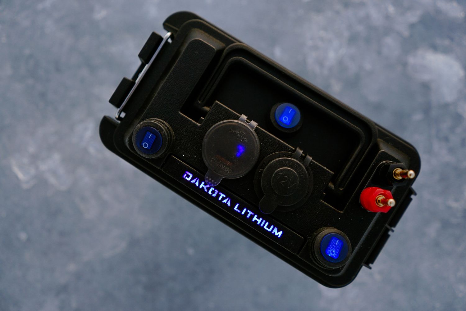 Top view of Dakota Lithium battery unit showing blue illuminated connection ports.