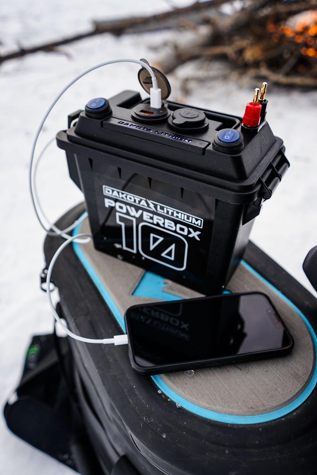 Close-up of black Powerbox 174 ice fishing device with blue accent details.