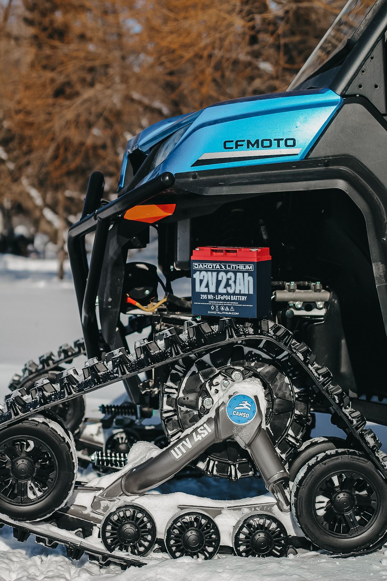 CFMOTO snowmobile track system with Dakota Lithium power unit mounted in winter setting.