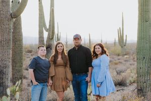 Group photo session in natural desert setting with iconic saguaro cacti backdrop.