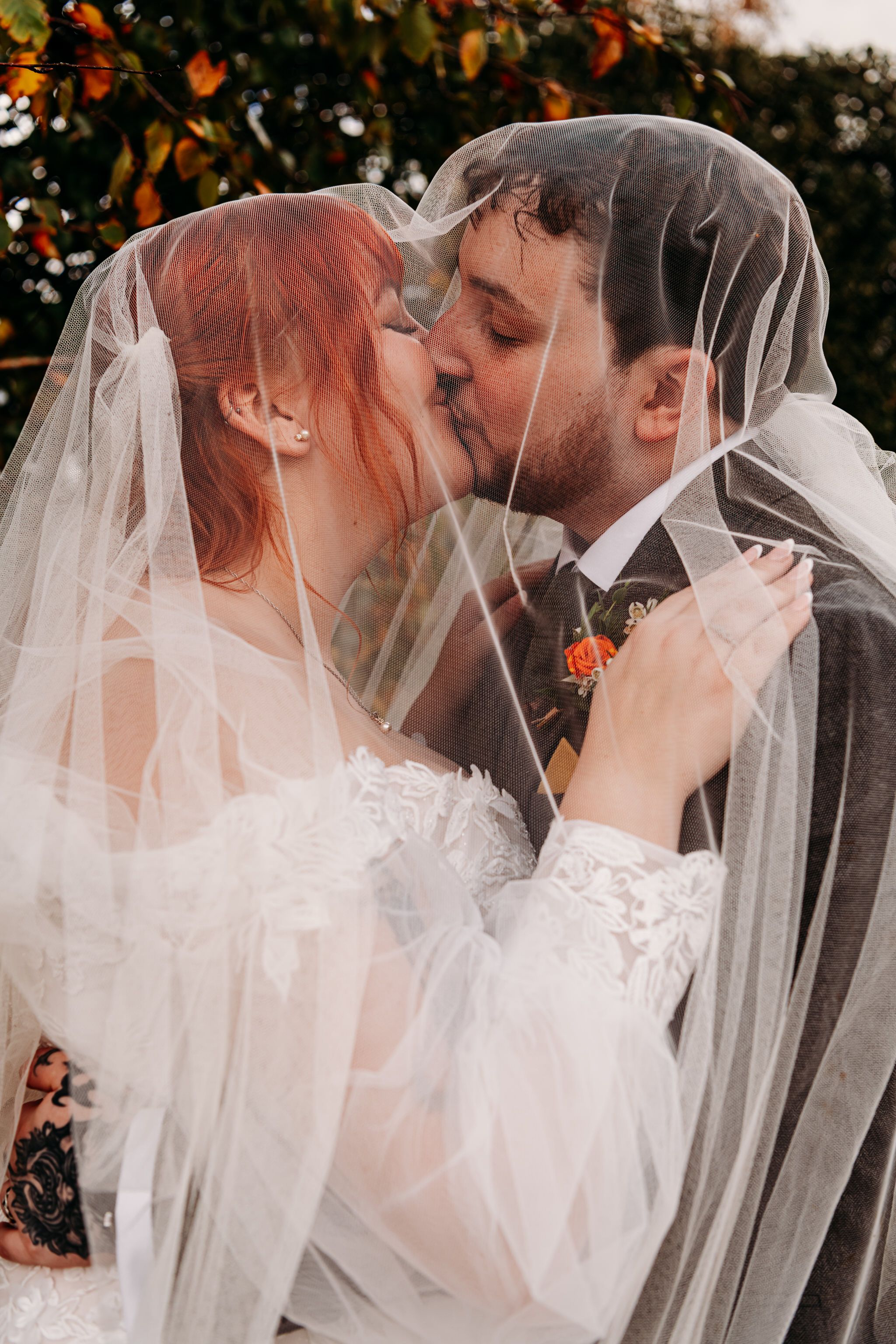 A romantic sequence of wedding photos showing a couple kissing under a flowing white veil with autumn leaves in background.
