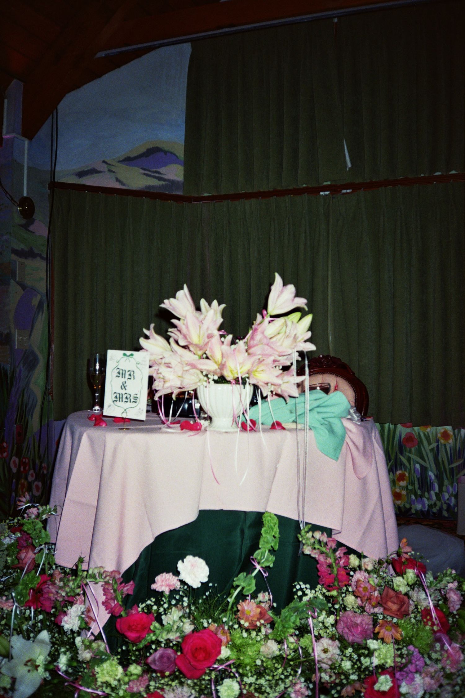 Wedding Sweetheart Table surrounded my colorful eclectic florals in the Garden Room at Madonna Inn in San Luis Obispo