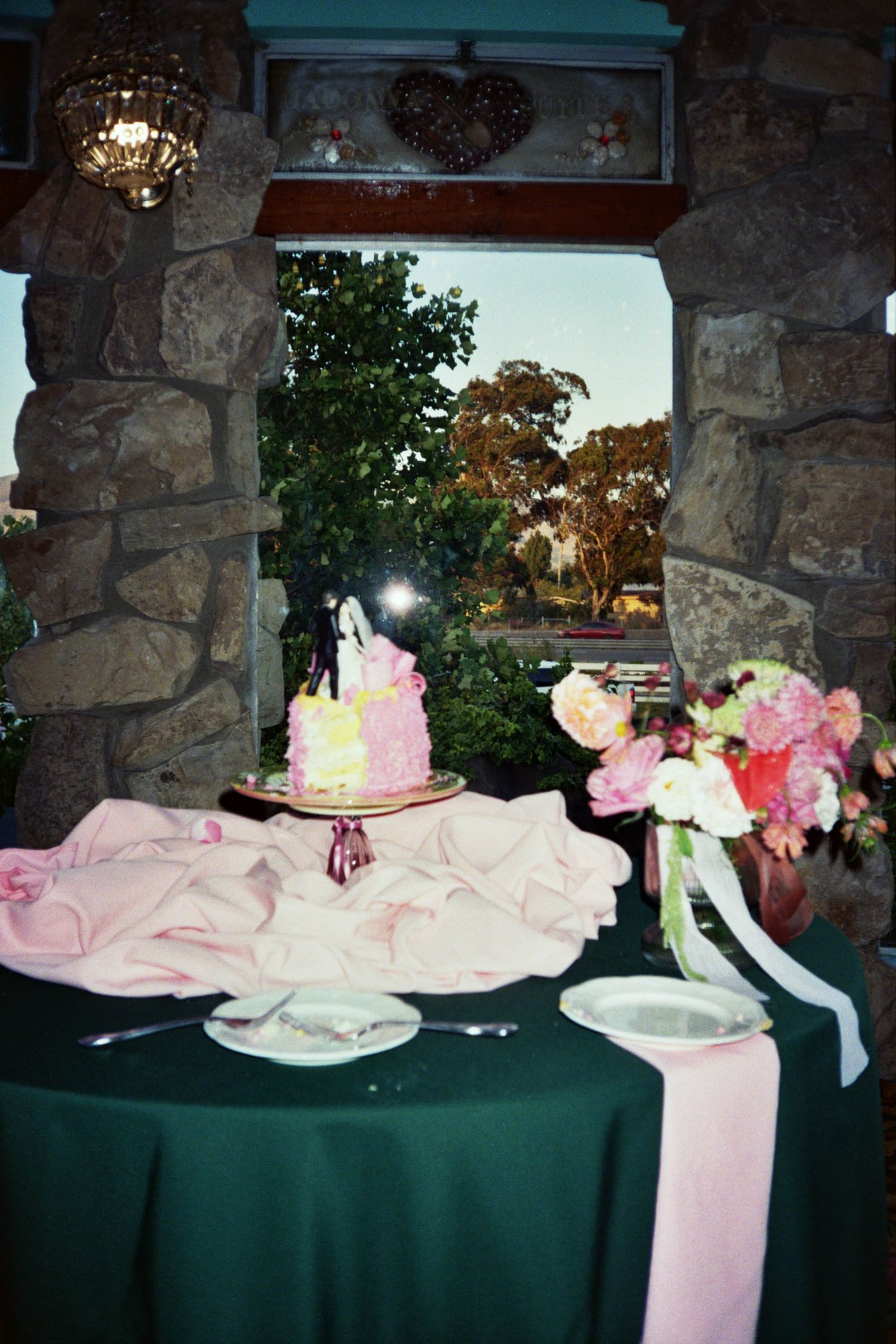 Wedding Cake Table surrounded with colorful eclectic florals in the Garden Room at Madonna Inn in San Luis Obispo