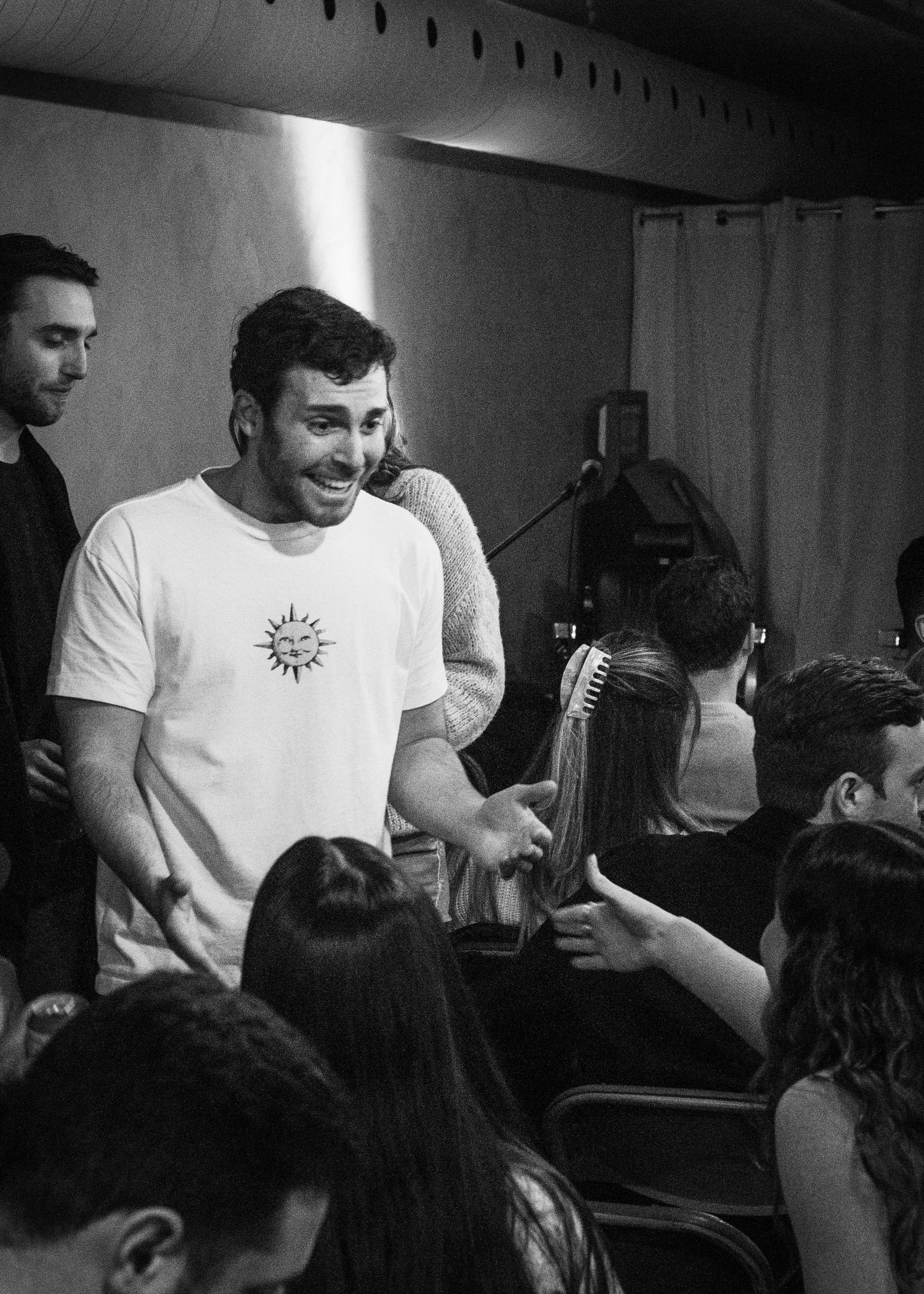 Event photography capturing live moments from the 'Mess Produced' comedy show with performers on stage and audience reactions.