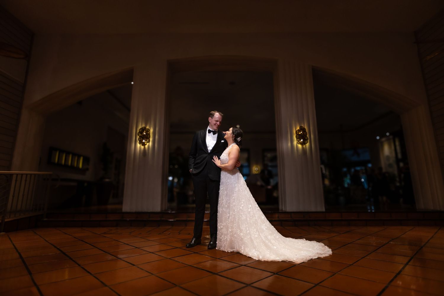 A romantic ballroom wedding dance captured with dramatic lighting and ambiance.