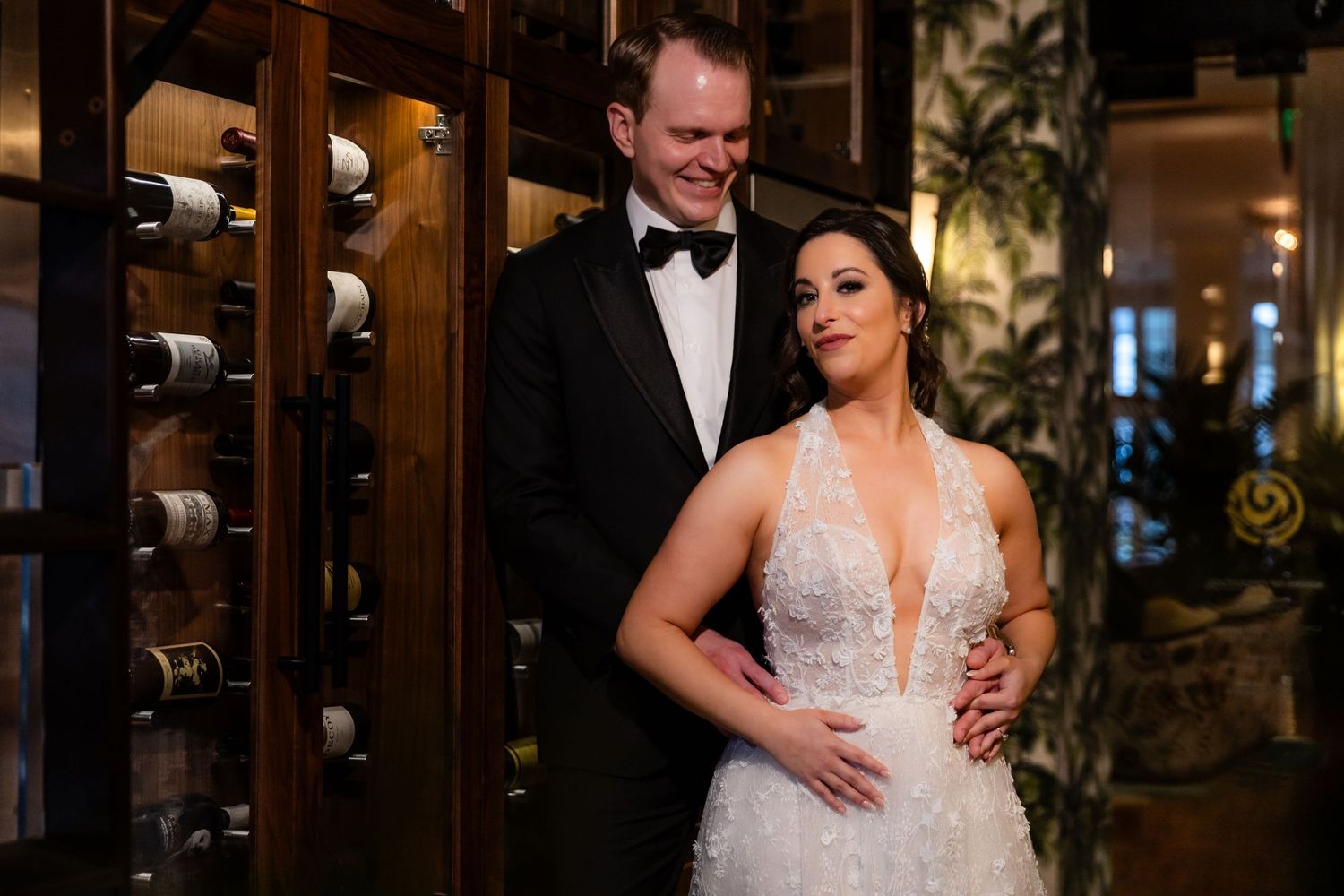 Romantic couple sharing a dance in an elegant wood-paneled venue.