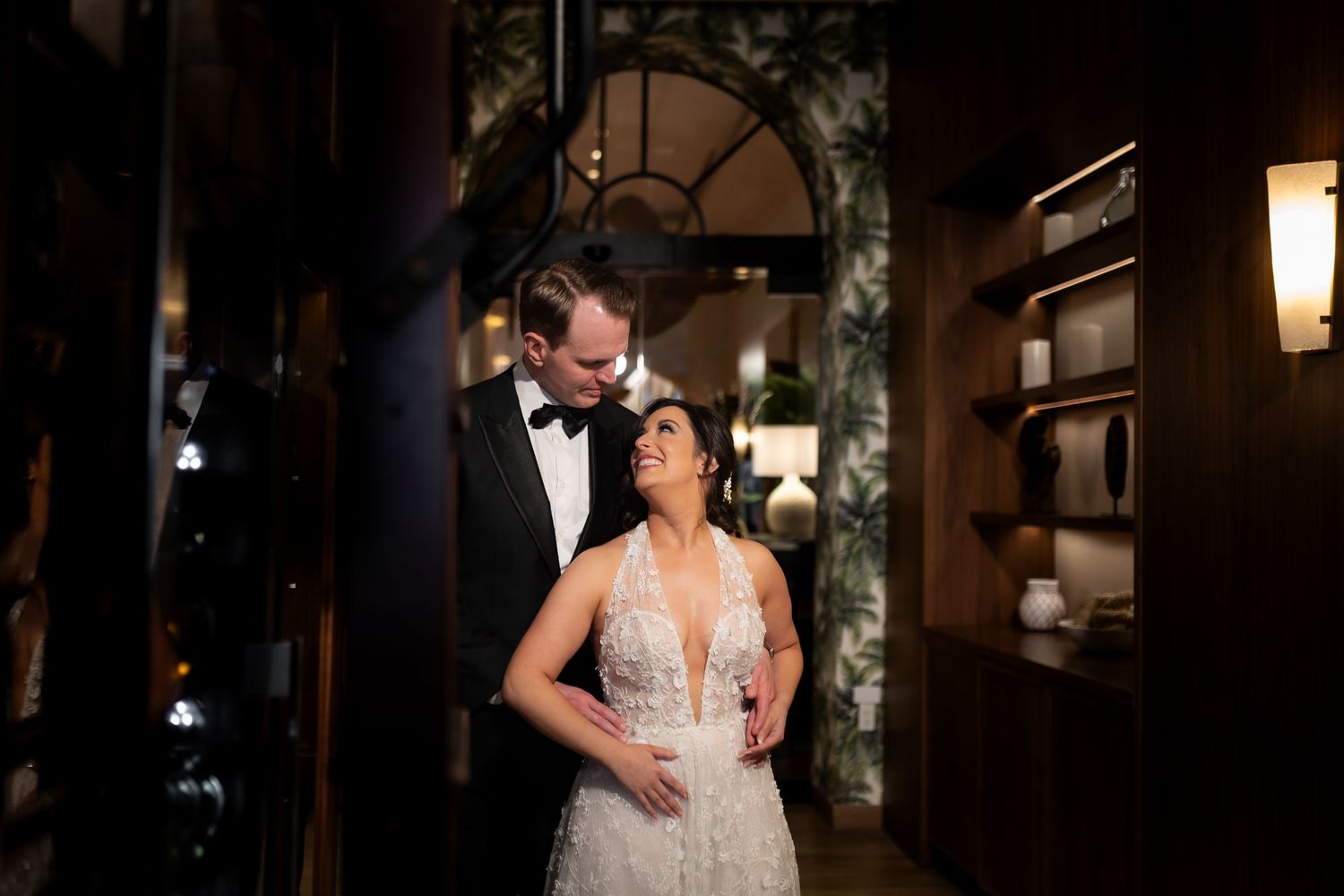 Romantic first dance between newlyweds at an elegant indoor wedding reception.