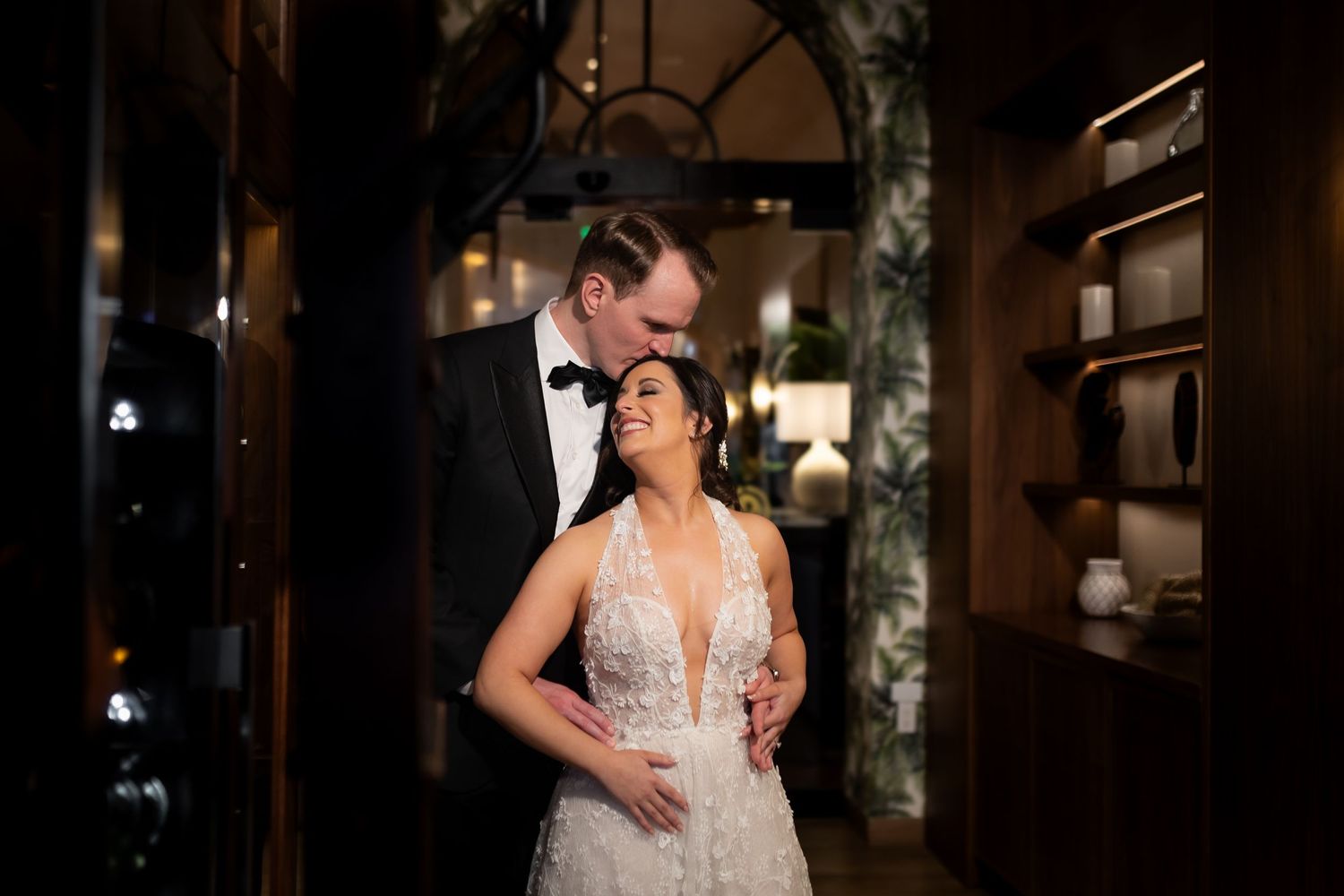 Intimate wedding moment captured in a dimly lit elegant venue.