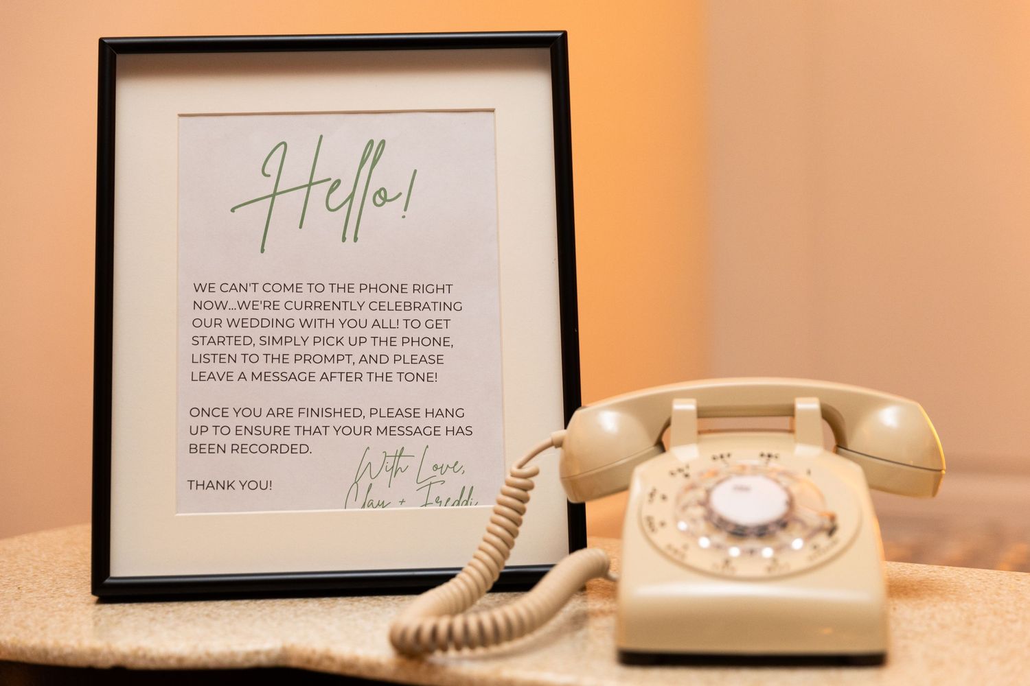 Vintage rotary telephone and framed wedding details on display at reception.