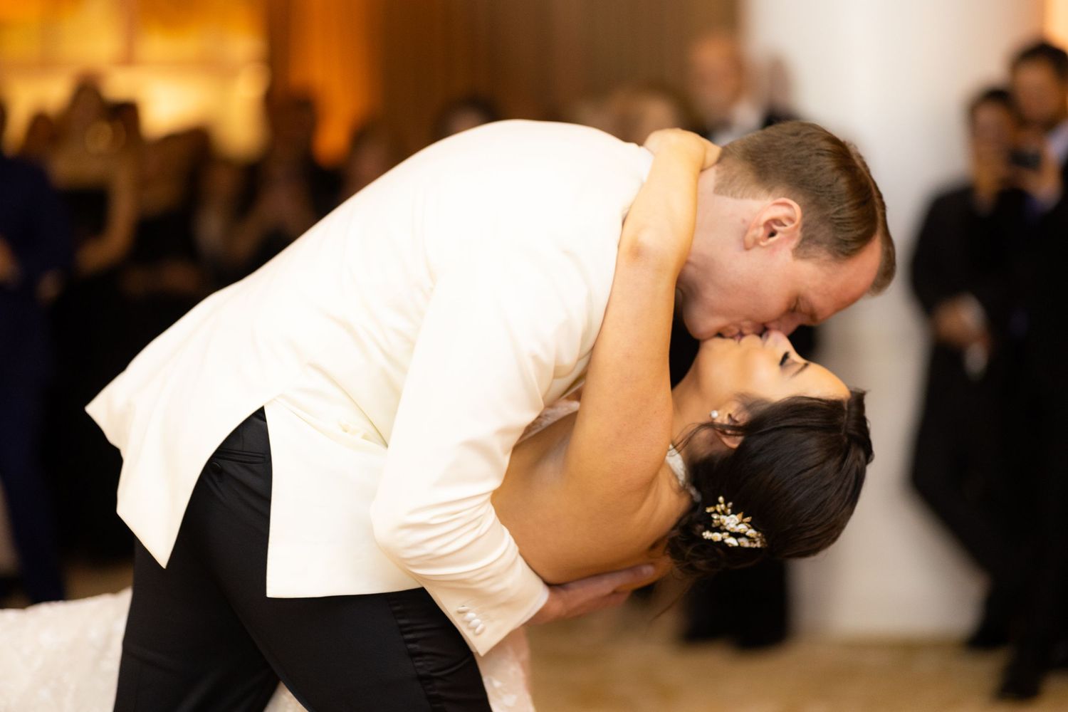 Intimate dance moment captured at wedding reception with warm ambient lighting.