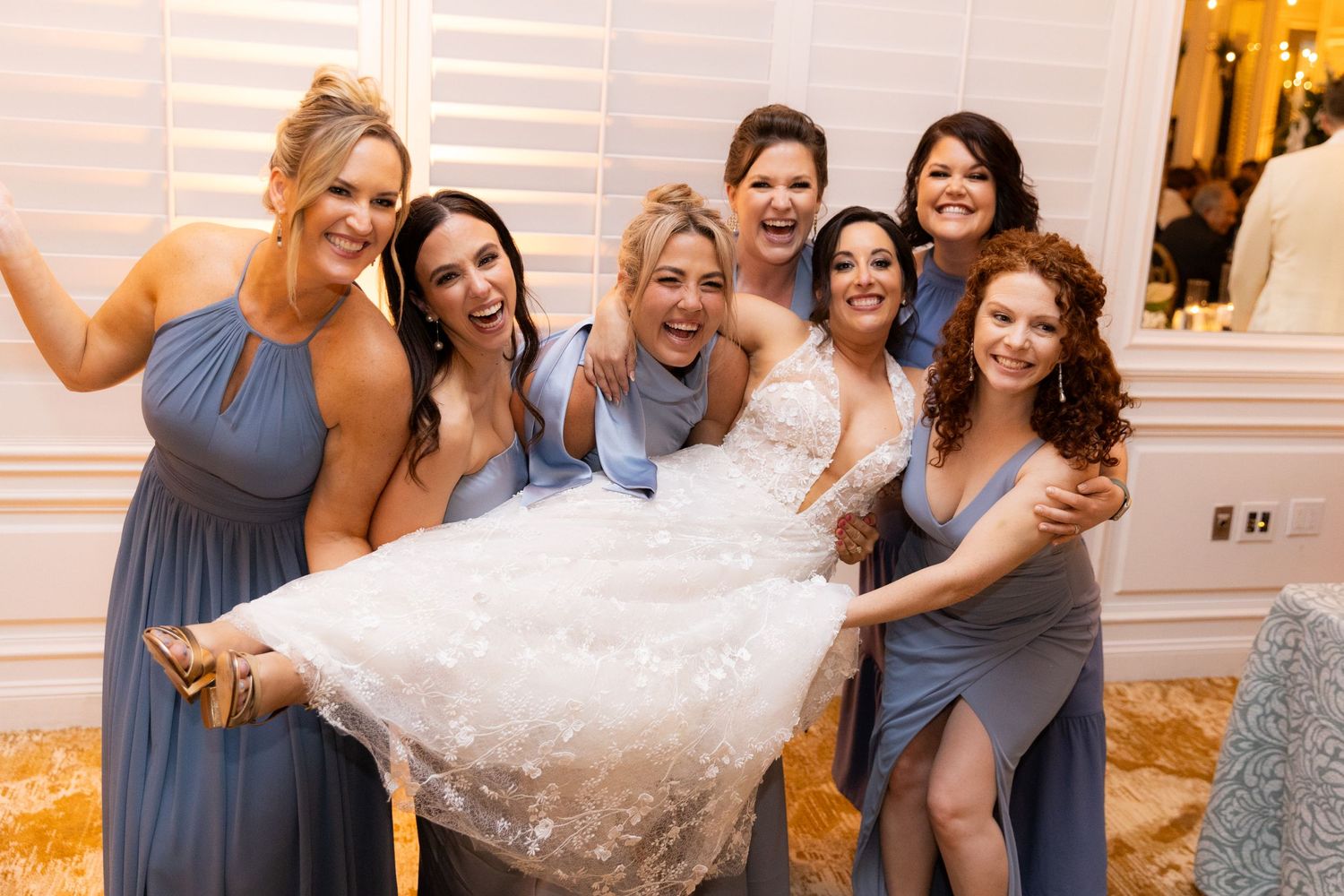Wedding party members dance and celebrate during lively reception.