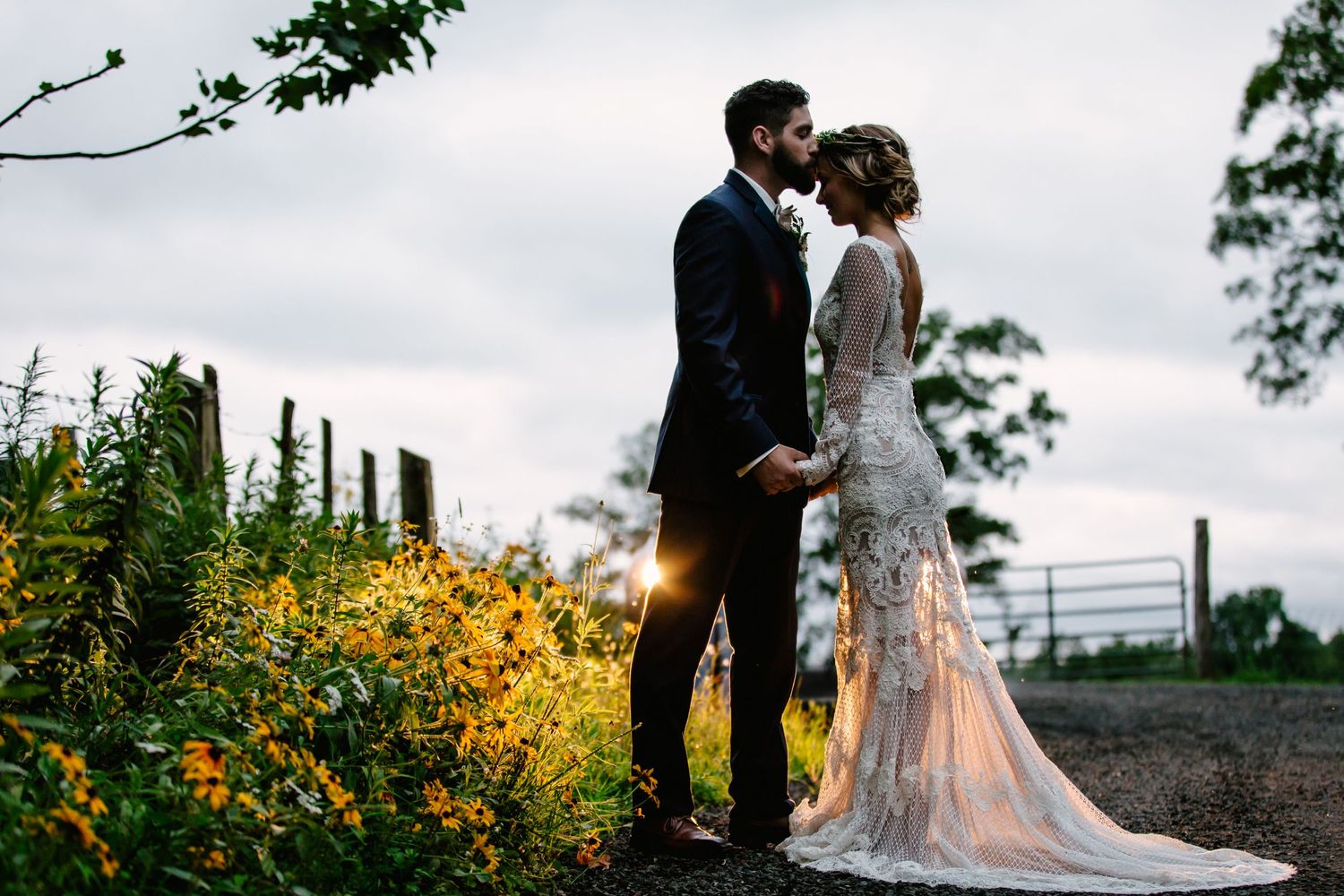 A romantic garden wedding scene with yellow wildflowers in the foreground.