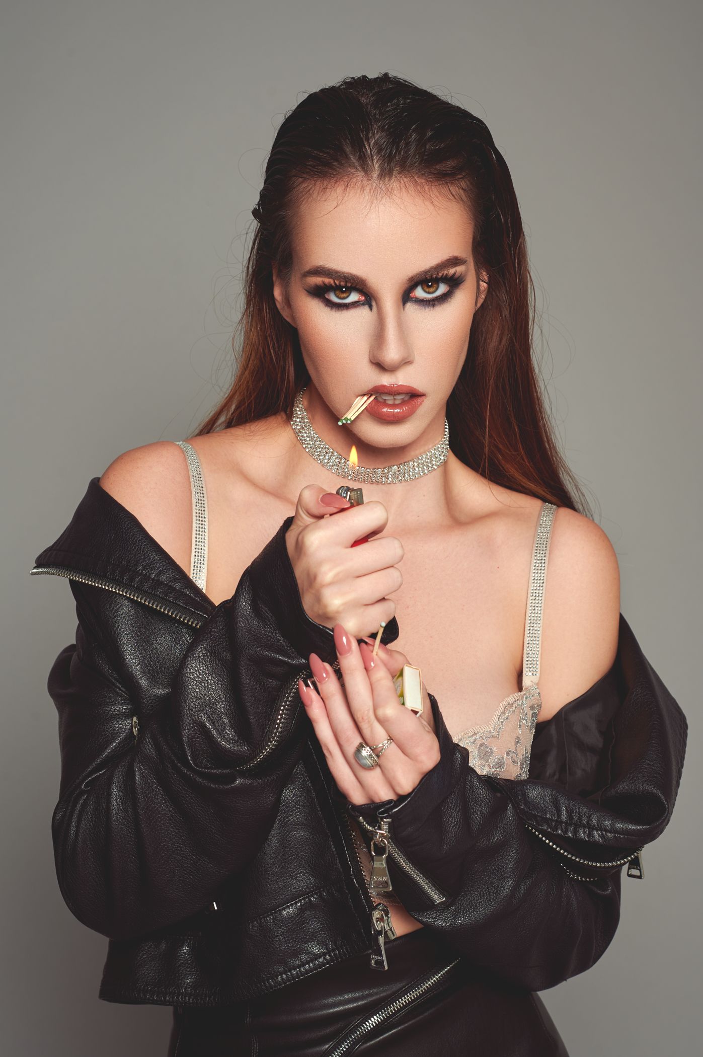 Fashion portrait with model in black leather jacket and silver accessories.