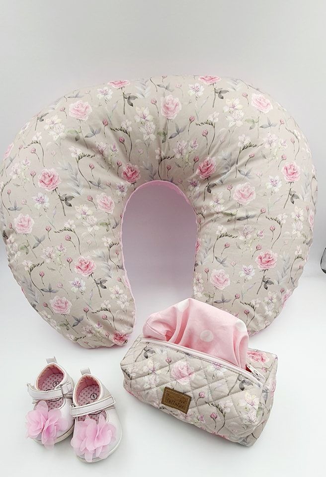 Quilted nursing pillow in vintage rose pattern with matching pink baby shoes.