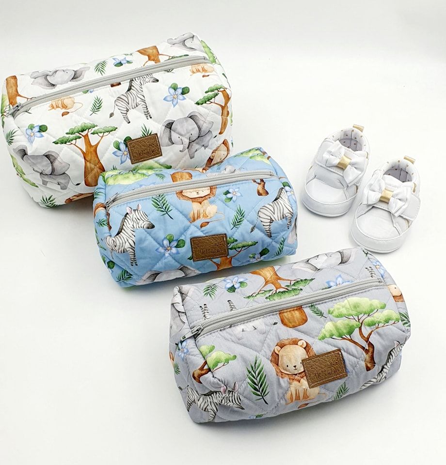 Safari themed baby blanket with cute animal prints and coordinating accessories.