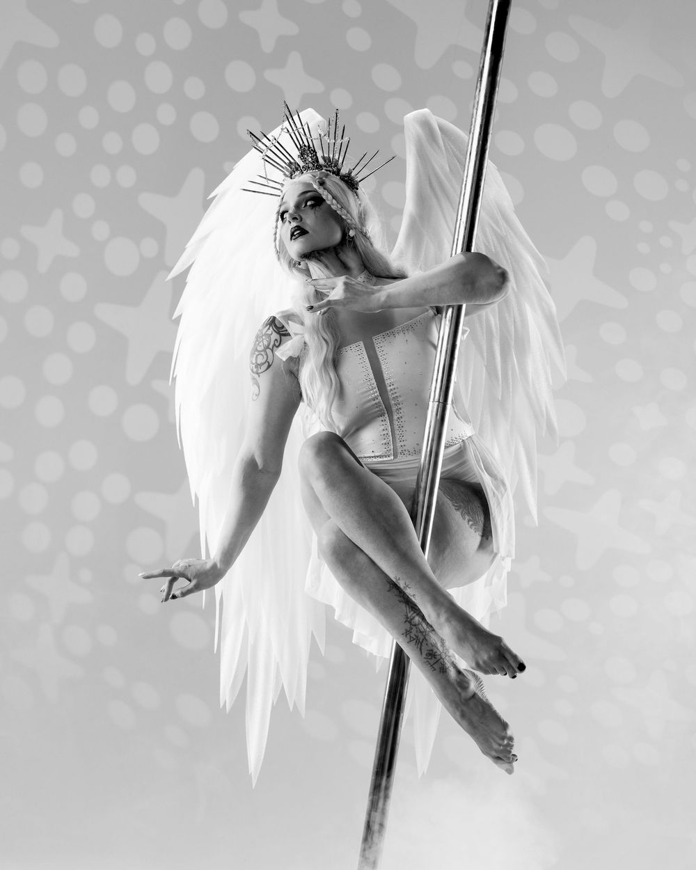 Pole dancer on light backdrop; professional aerial arts and pole photography, aerial portraits. Real angel wings. Red Fox Photo by Natalie.