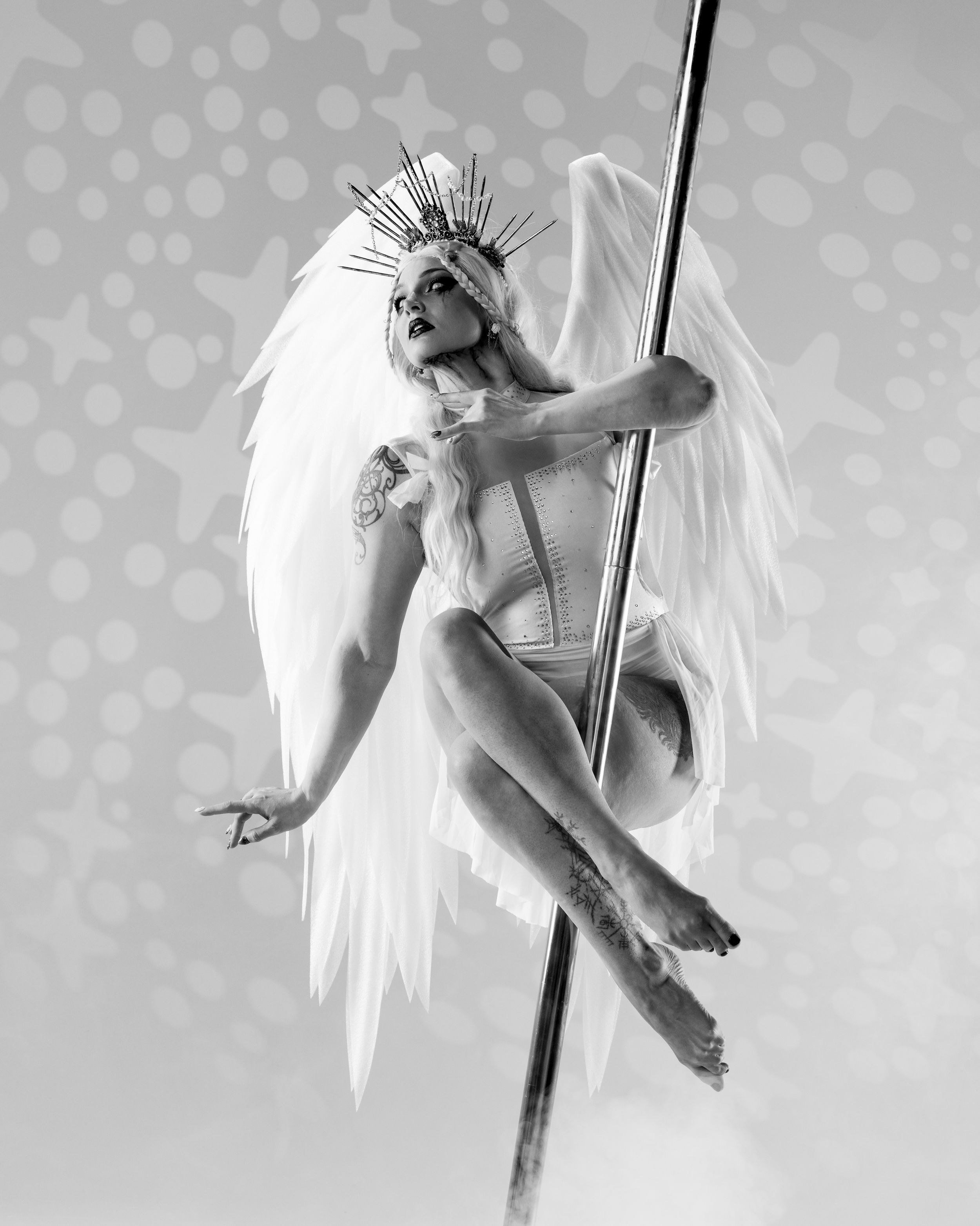 Pole dancer on light backdrop; professional aerial arts and pole photography, aerial portraits. Real angel wings. Red Fox Photo by Natalie.