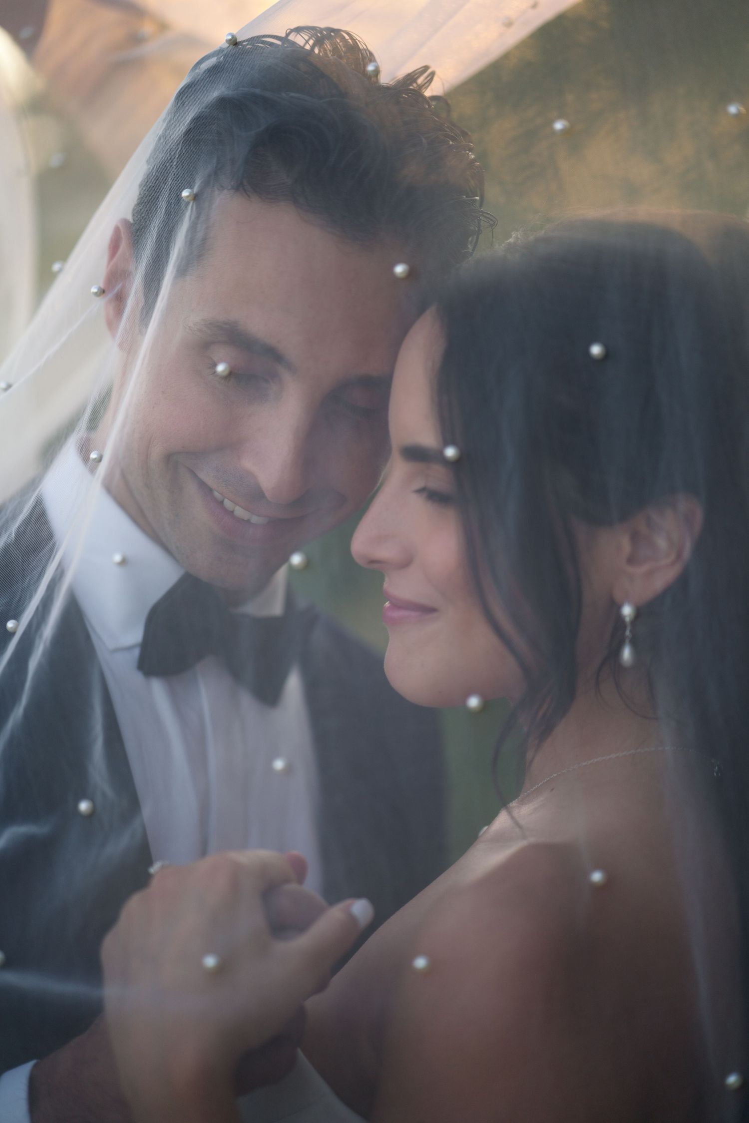 Intimate wedding portrait with soft bokeh effect and dreamy lighting.