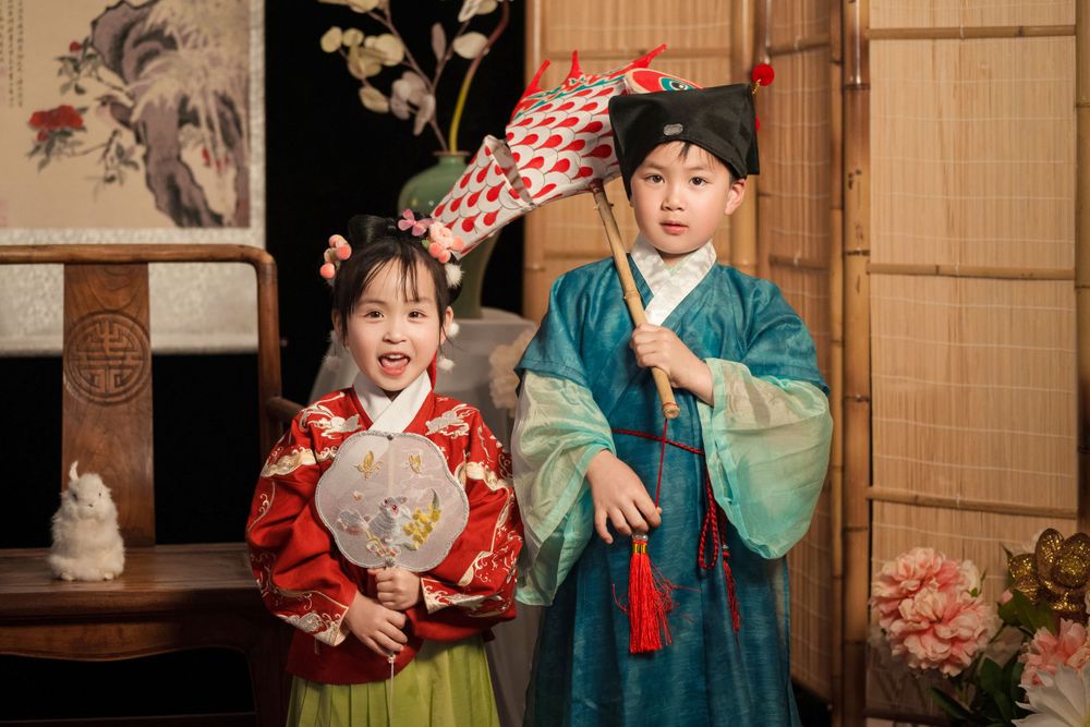 Happy family enjoying cozy home activities in Ming Dynasty Hanfu with soft studio lighting, by Imagine Image Studio Auckland.