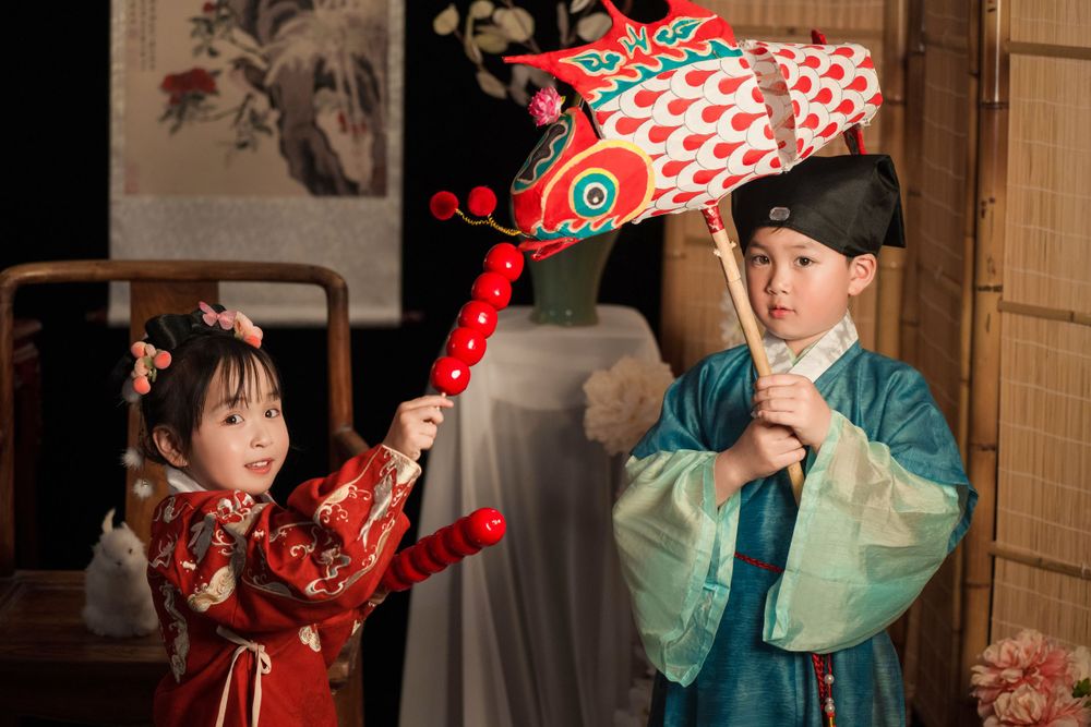 Happy family enjoying cozy home activities in Ming Dynasty Hanfu with soft studio lighting, by Imagine Image Studio Auckland.