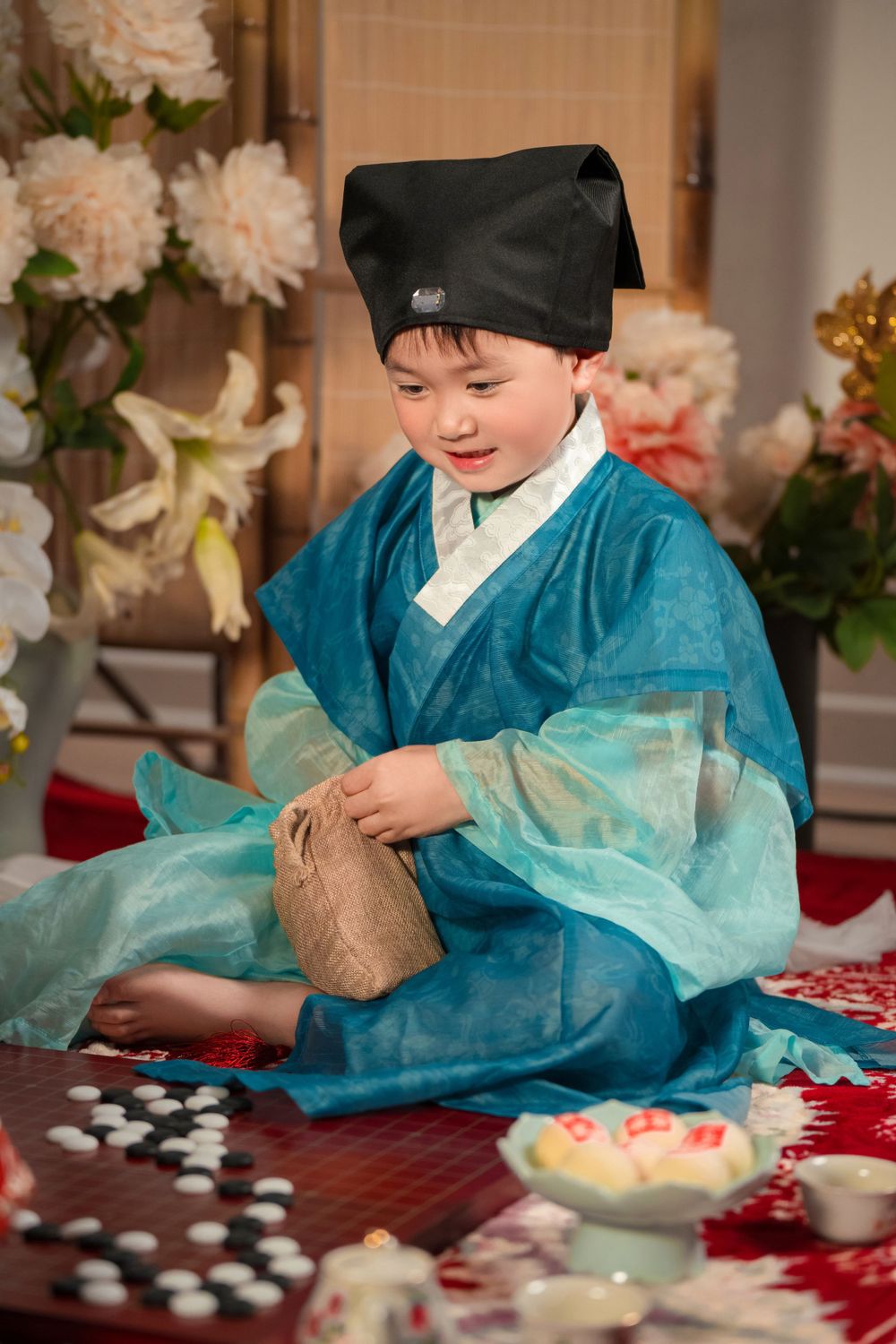 Happy family enjoying cozy home activities in Ming Dynasty Hanfu with soft studio lighting, by Imagine Image Studio Auckland.
