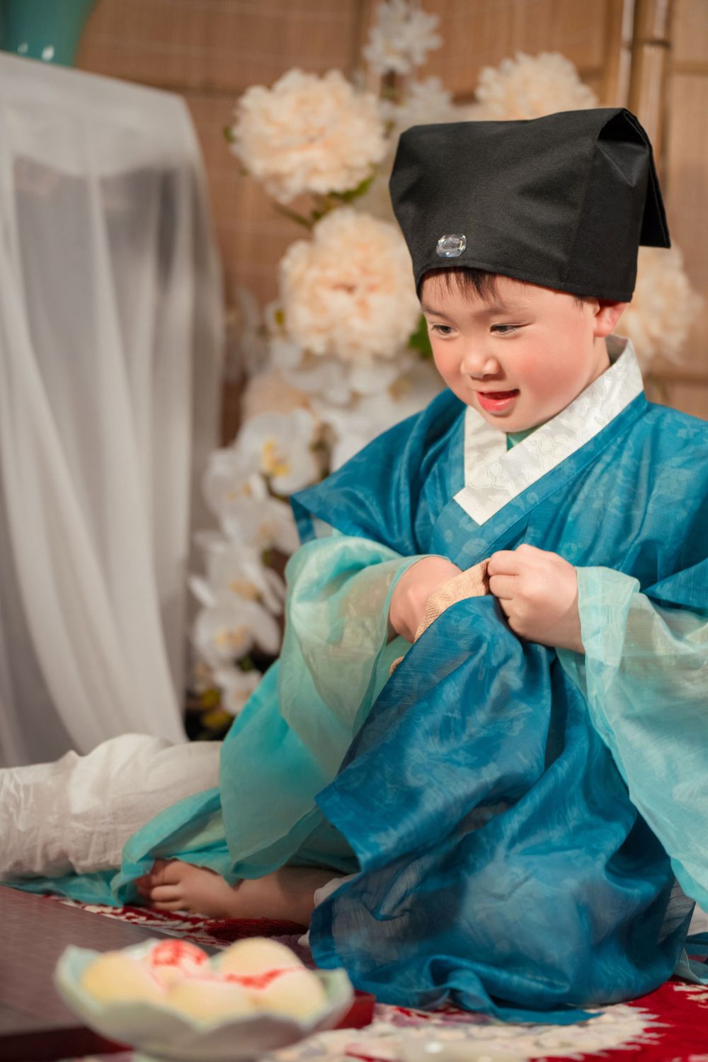 Happy family enjoying cozy home activities in Ming Dynasty Hanfu with soft studio lighting, by Imagine Image Studio Auckland.