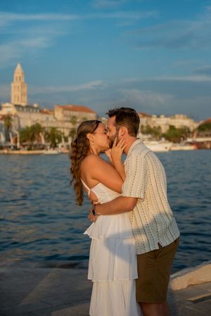 Romantic moment captured along Split's waterfront with historic architecture in background.