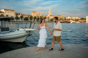 Waterfront proposal scene in Split with boats and historic architecture in background.