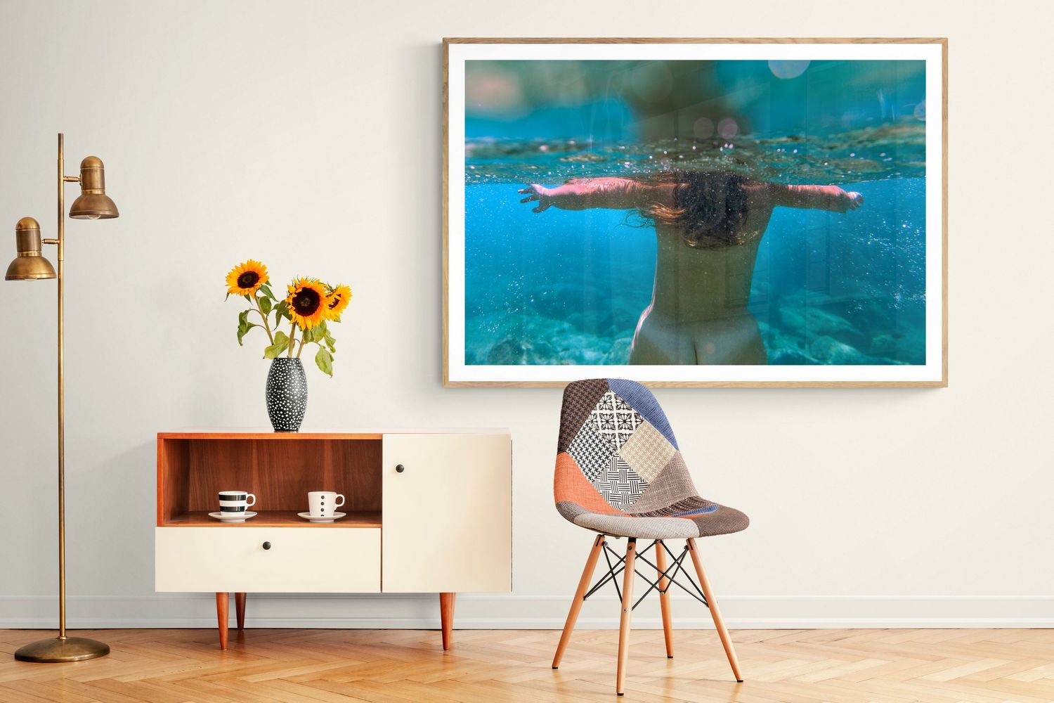 Artistic underwater photograph displayed in modern room with sunflowers and mid-century furniture.