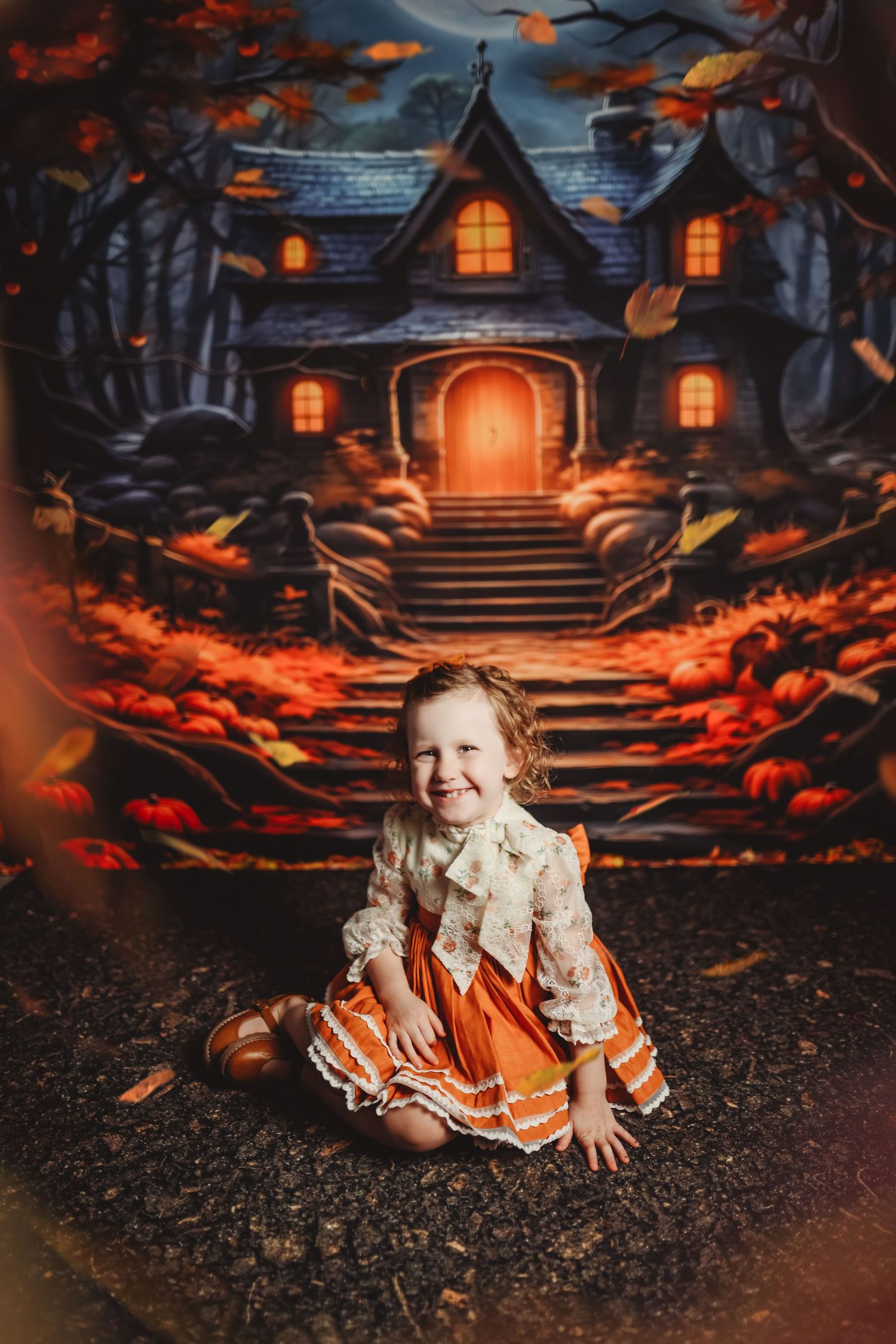 Halloween themed photo with glowing houses and orange pumpkins in a spooky setting.