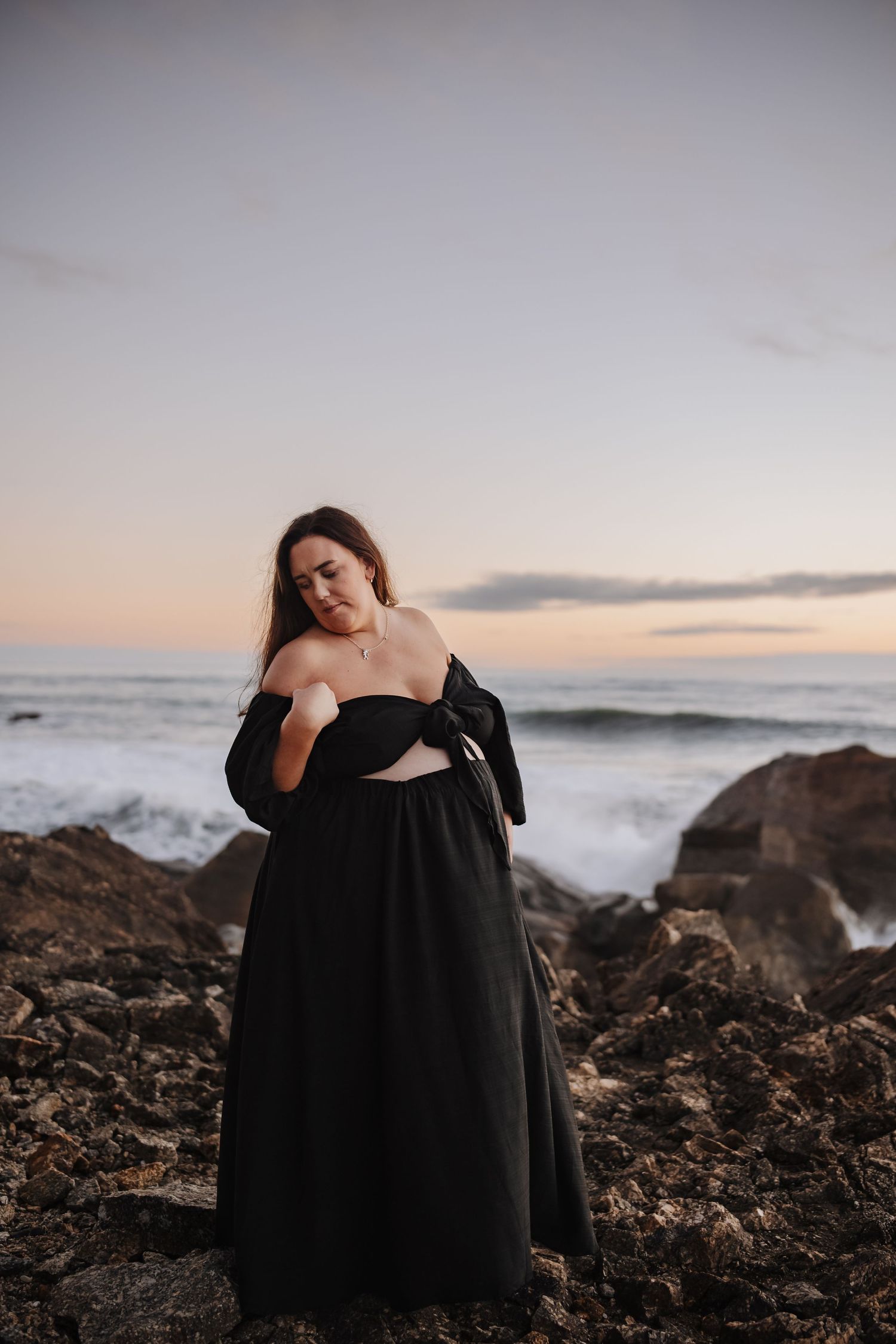 Maternity portrait of expectant mother during golden-hour at beach Westport NZ