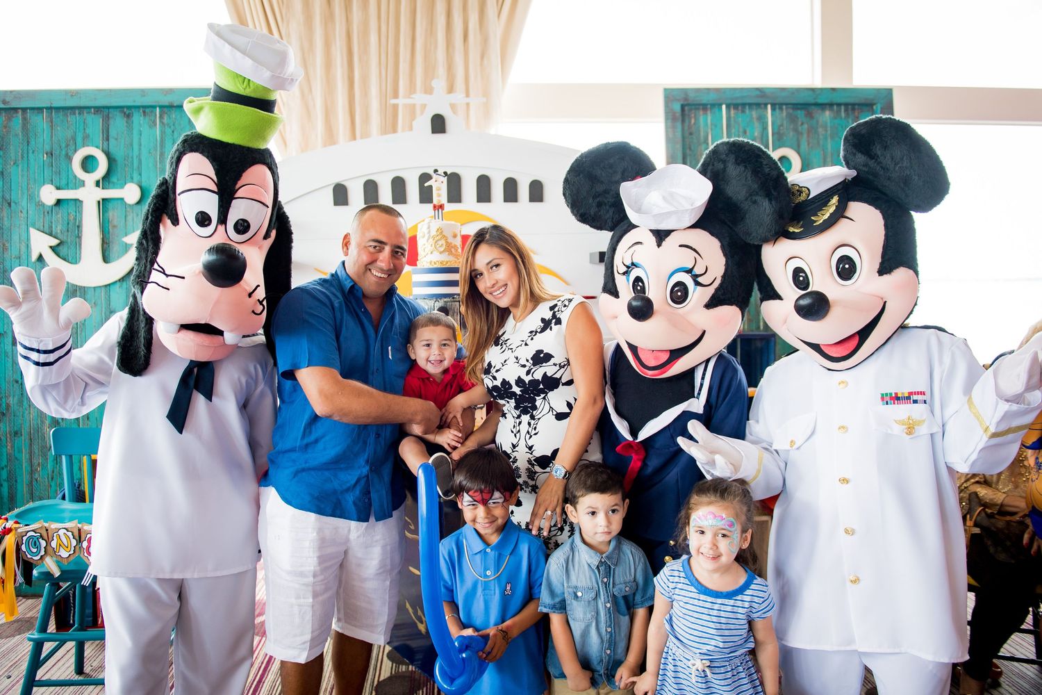 Guests pose with Goofy, Mickey and Minnie Mouse characters in a nautical-themed, Disney Cruise Lines Party.