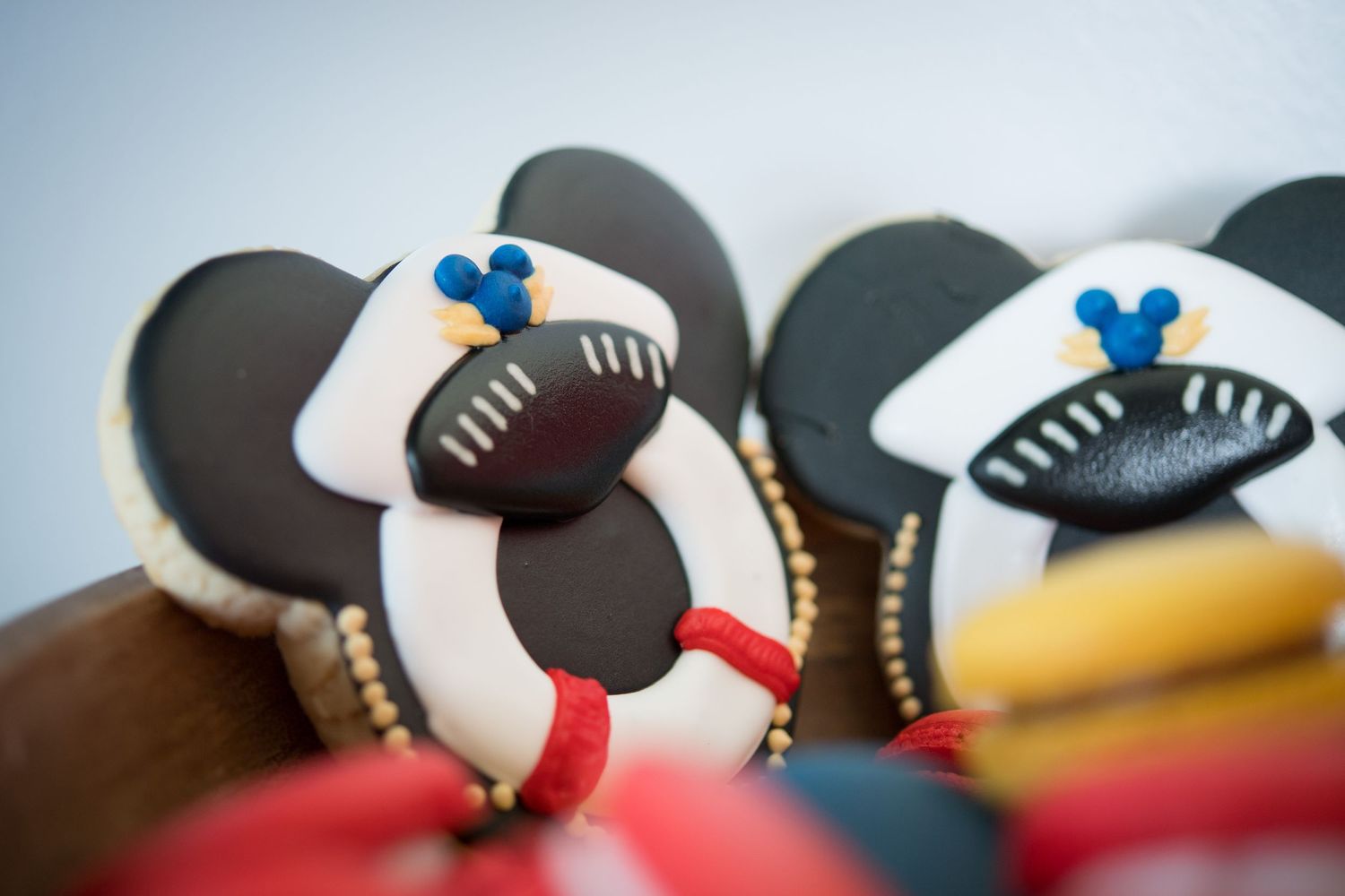 Close-up view of artistic cookies featuring Mickey Mouse-inspired designs with nautical elements.