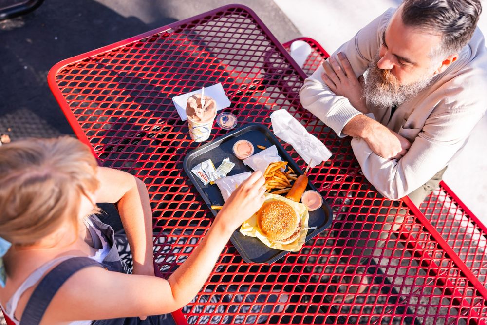 Salt Lake City Utah Photographer, candid relaxed couple on a date night at a drive through diner in sugar house with burgers and fries