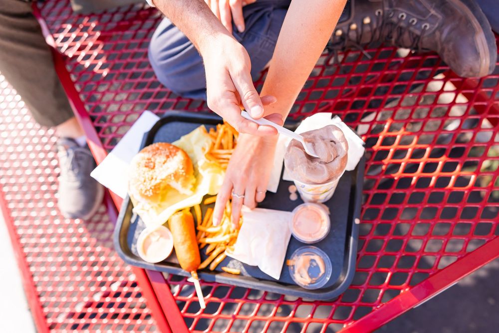 Salt Lake City Utah Photographer, candid relaxed couple on a date night at a drive through diner in sugar house with burgers and fries