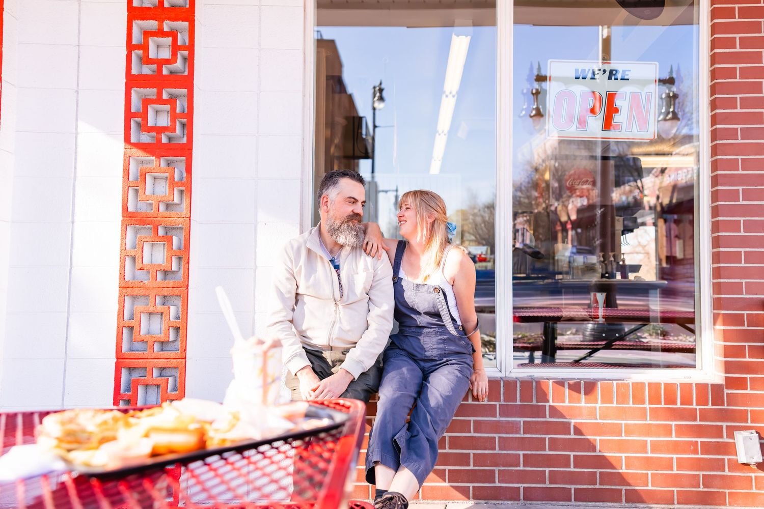 Salt Lake City Utah Photographer, candid relaxed couple on a date night at a drive through diner in sugar house with burgers and fries
