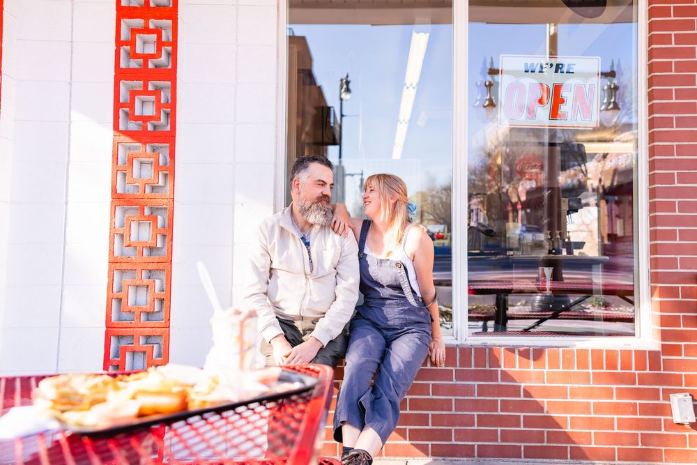 Salt Lake City Utah Photographer, candid relaxed couple on a date night at a drive through diner in sugar house with burgers and fries