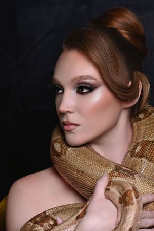 Luxury Beauty Portrait of Miranda with Boa constrictor featured Golden Editorial Lighting by Marley Domeck