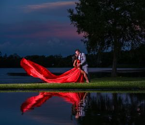 Luxury Flying Dress Reflection Portrait of elegant couple at Sunset by Marley Domeck