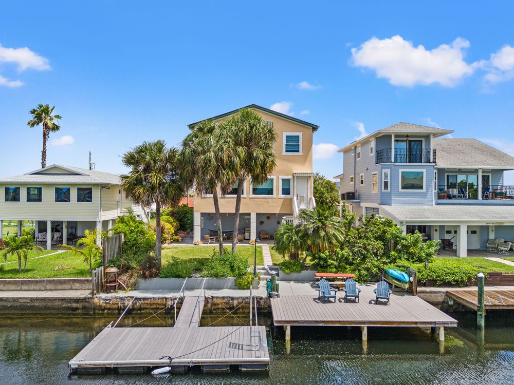 Waterfront properties with docks and boats along a residential canal.